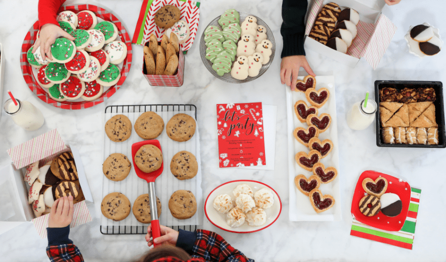 Tips and tricks for how to throw a Holiday Cookie Swap Party for kids. Includes ideas for invitations, setup, games, packaging, and favors for the ultimate Christmas Cookie Exchange!