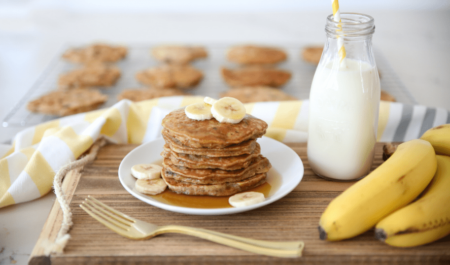 stack of banana pancakes with milk