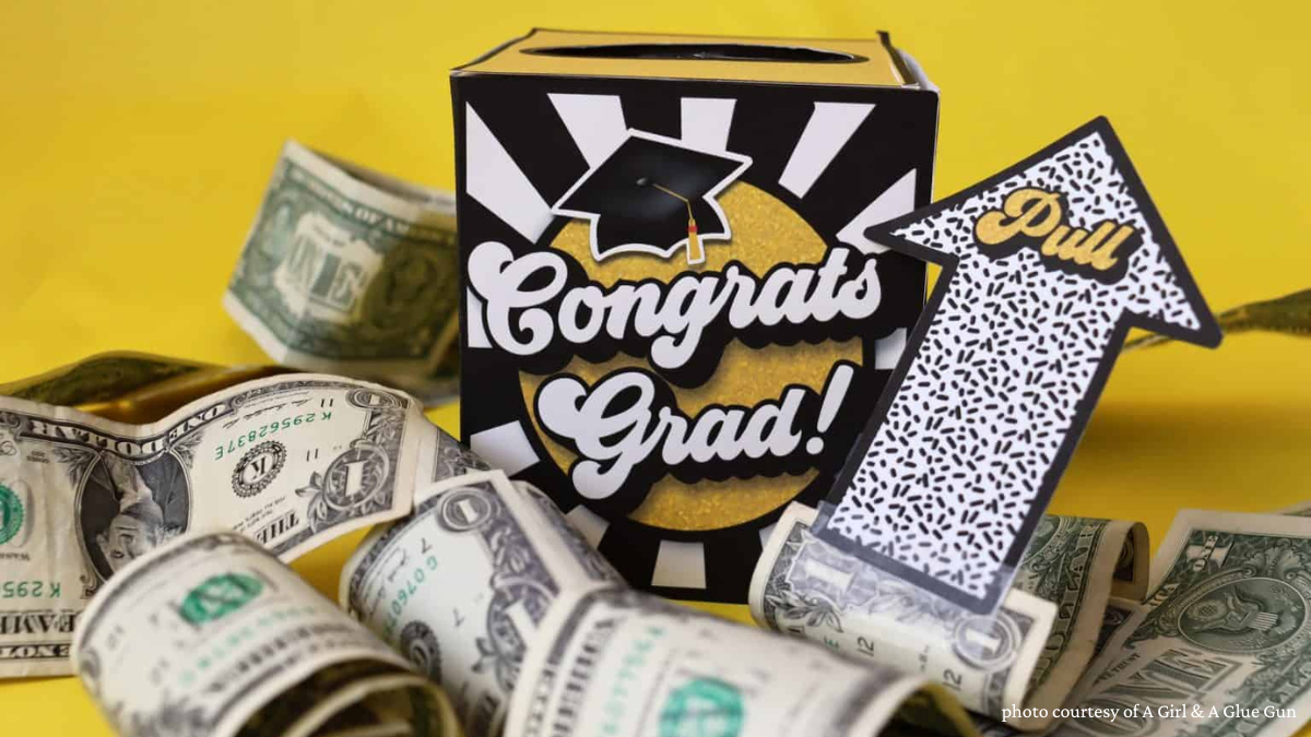 colorful box that says "Congrats Grad" with dollar bills all around it