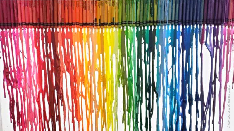 crayon wax dripping down canvas in rainbow of colors