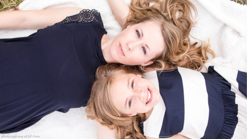 mother and daughter lying down opposite ways with heads next to each other
